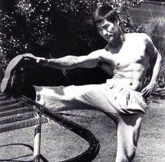 Bruce Lee stretching for flexibility before a workout