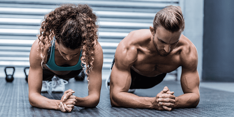 static holds male and female athlete perform plank exercises